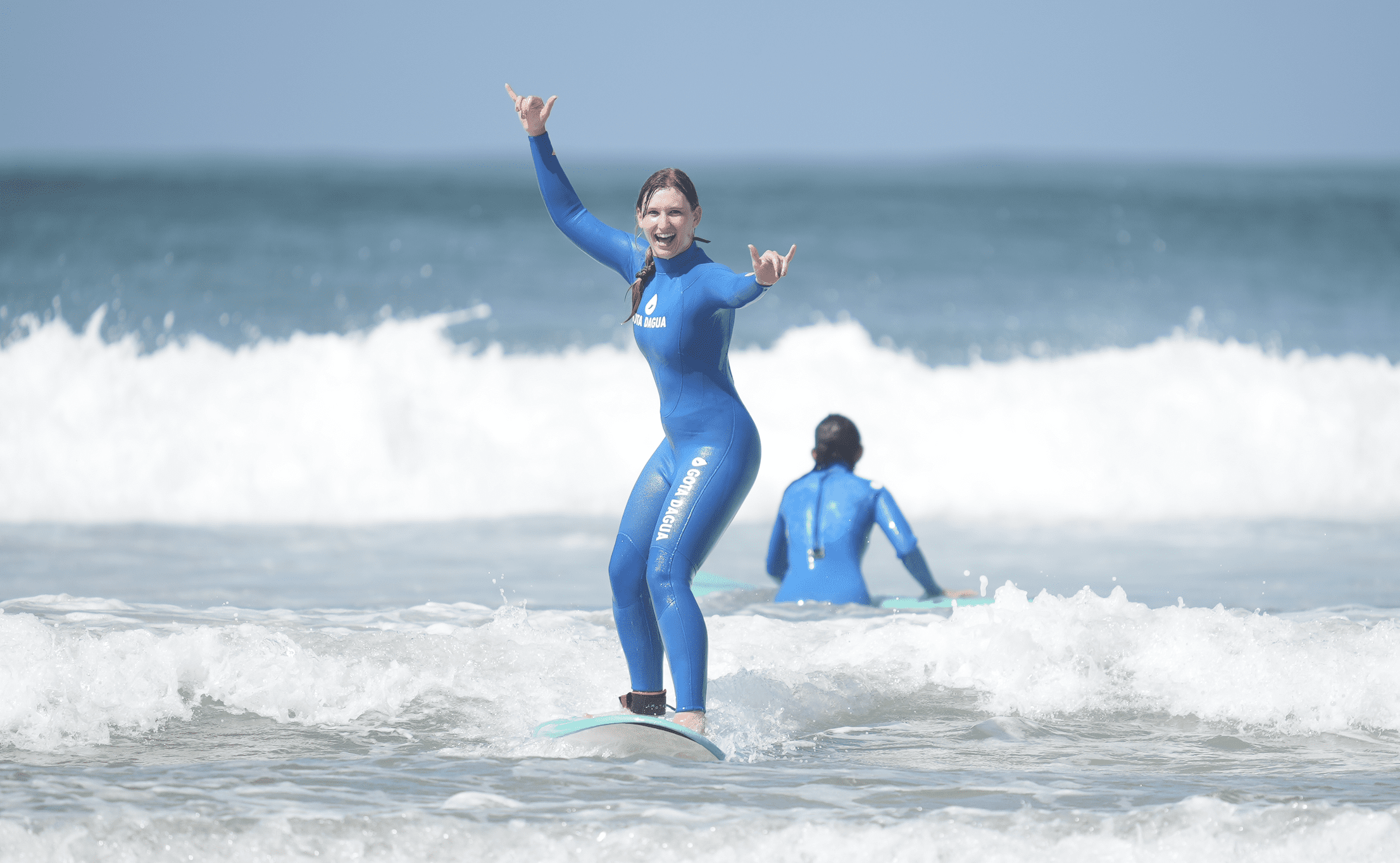A girl catching a wave in portugal, costa da caparica. The girl is surfing!