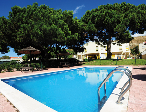 Outdoor pool surrounded by pines at our junior surf camp in Portugal
