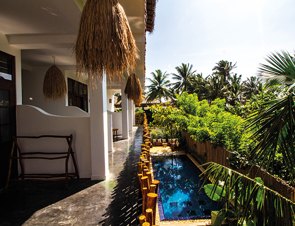 Balcony walkway with thatched shades looking down to the pool at our surf camp Sri Lanka